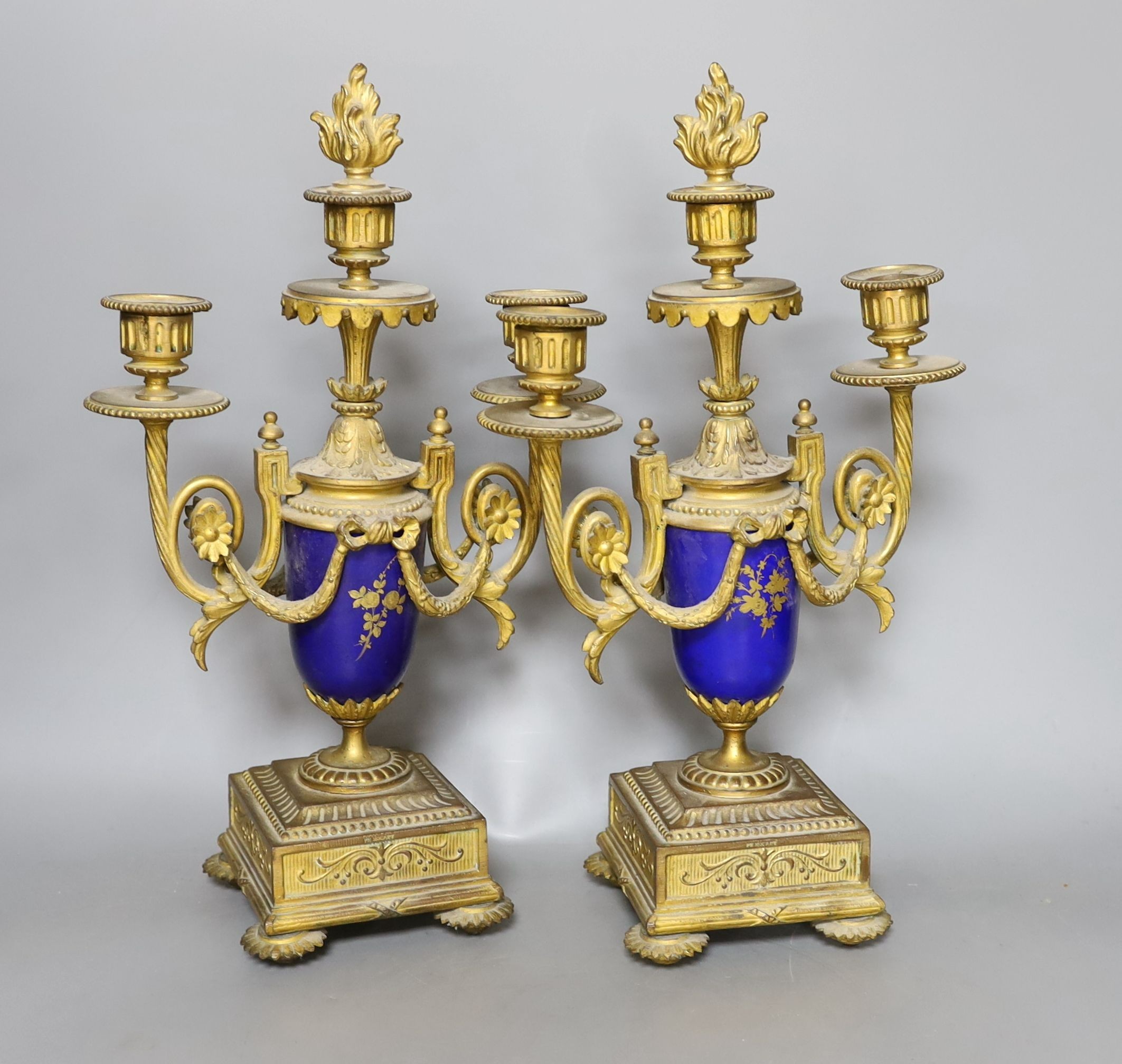 A pair of Sevres style porcelain and ormolu candelabra, 36 cms high.